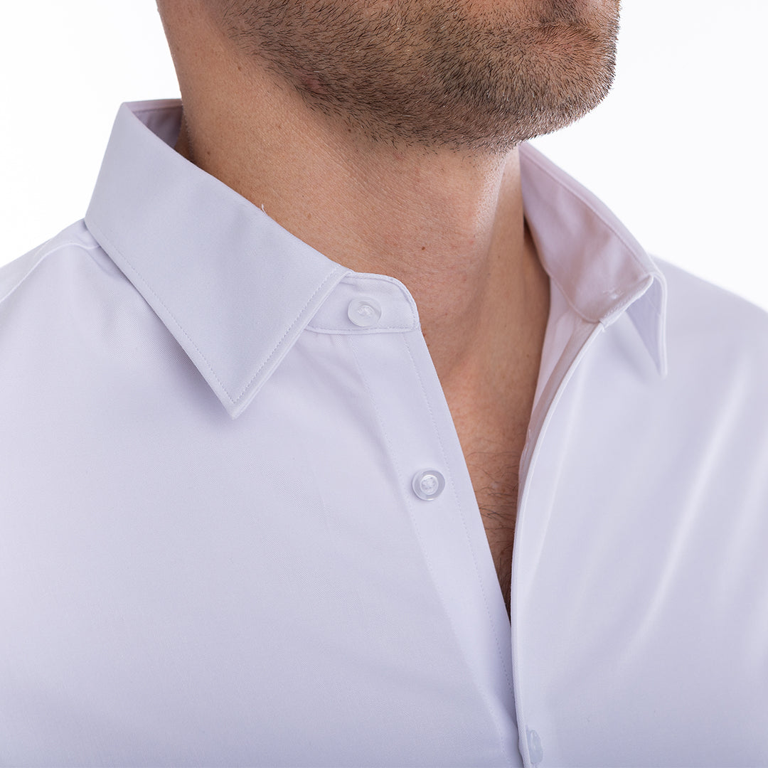 Crisp white dress shirt with open collar style holds its shape without ironing or starch.